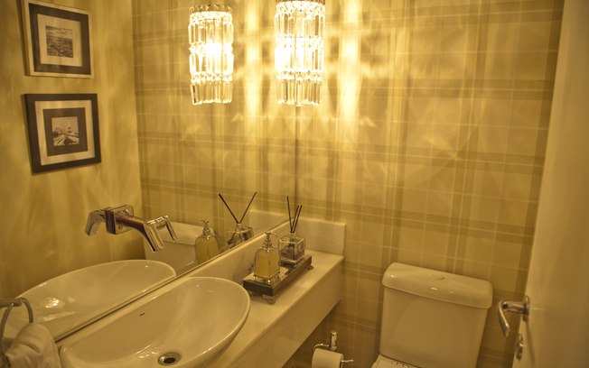 Espelho e papel de parede em listras são elementos que fazem com que o seu lavabo parece maior
